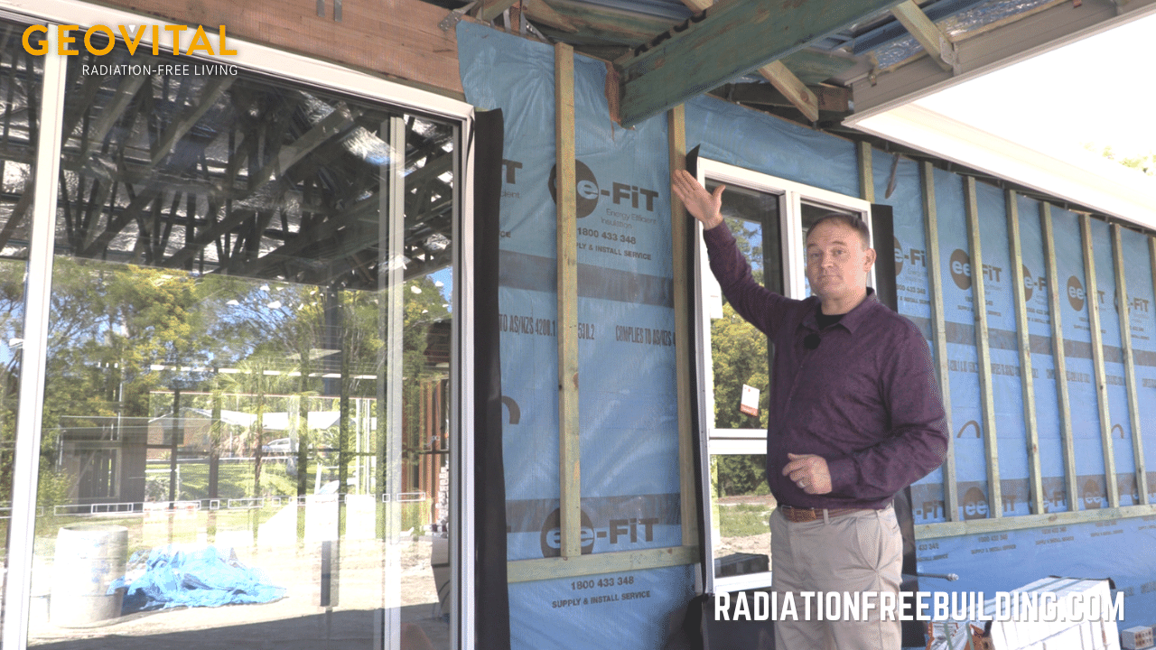 Patrick van der Burght showing GPA shielding mesh on the outside of a timber frame house